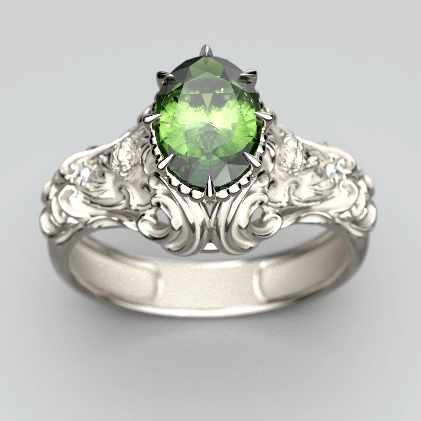 Top view of a green sapphire engagement ring in white gold, featuring a oval-cut sapphire with a sleek band design.