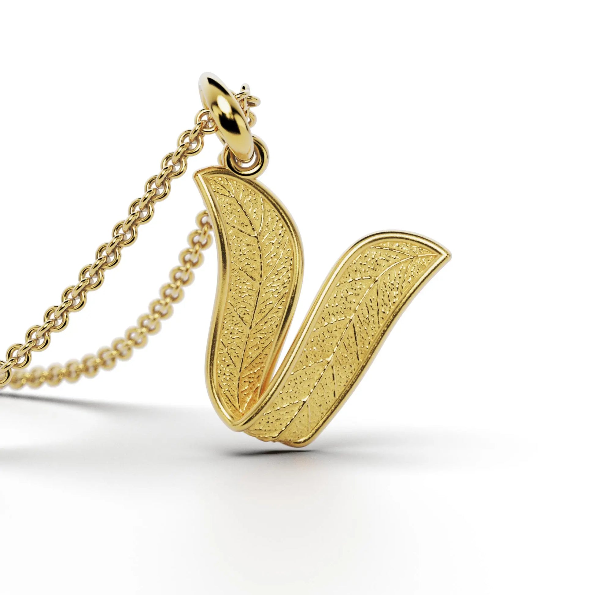 Gold initials pendant with leaf texture, custom made in Italy.
Letter V