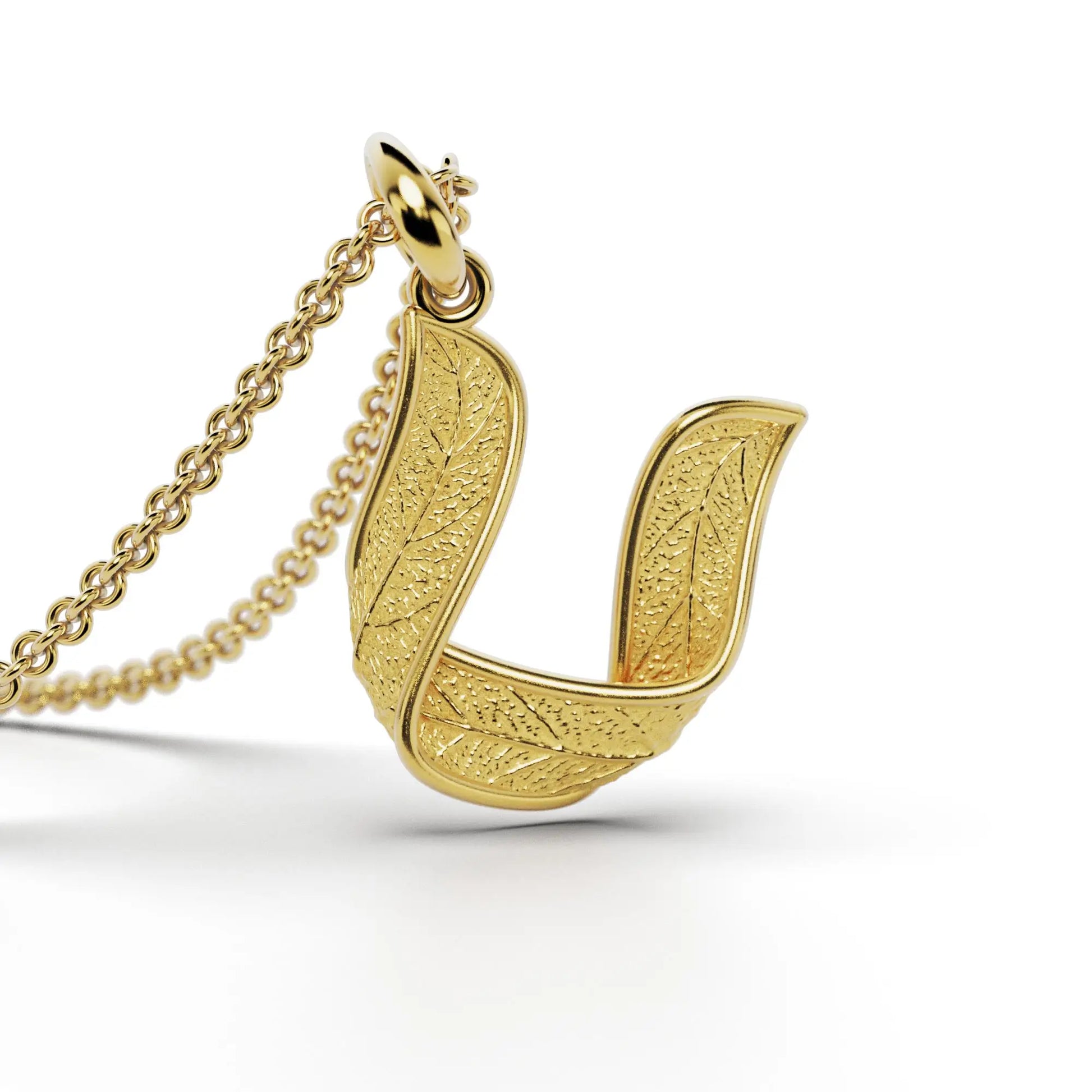 Gold initials pendant with leaf texture, custom made in Italy.
Letter U