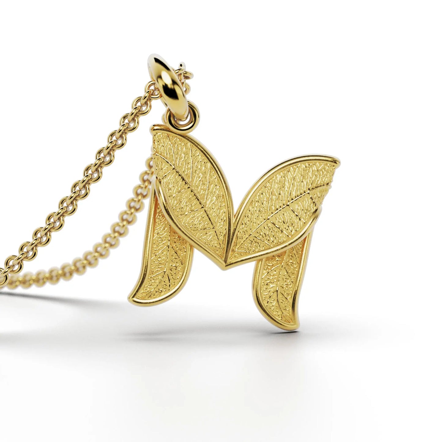 Gold initials pendant with leaf texture, custom made in Italy.
Letter M