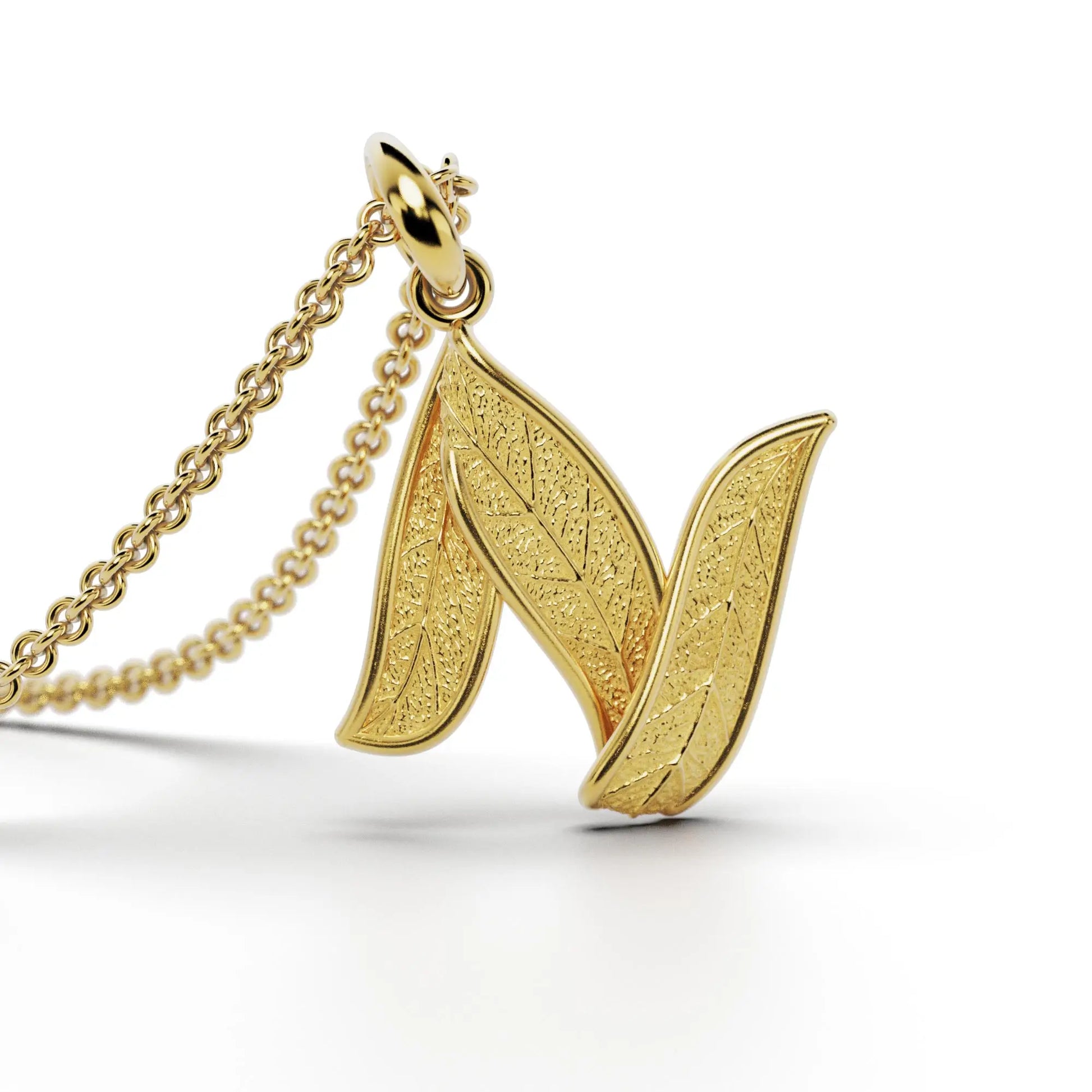 Gold initials pendant with leaf texture, custom made in Italy.
Letter N