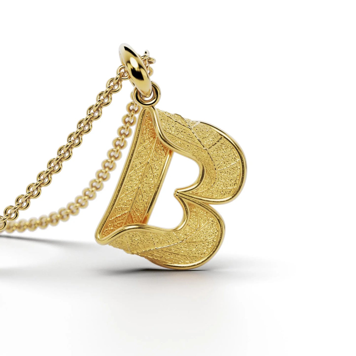 Gold initials pendant with leaf texture, custom made in Italy.
Letter B