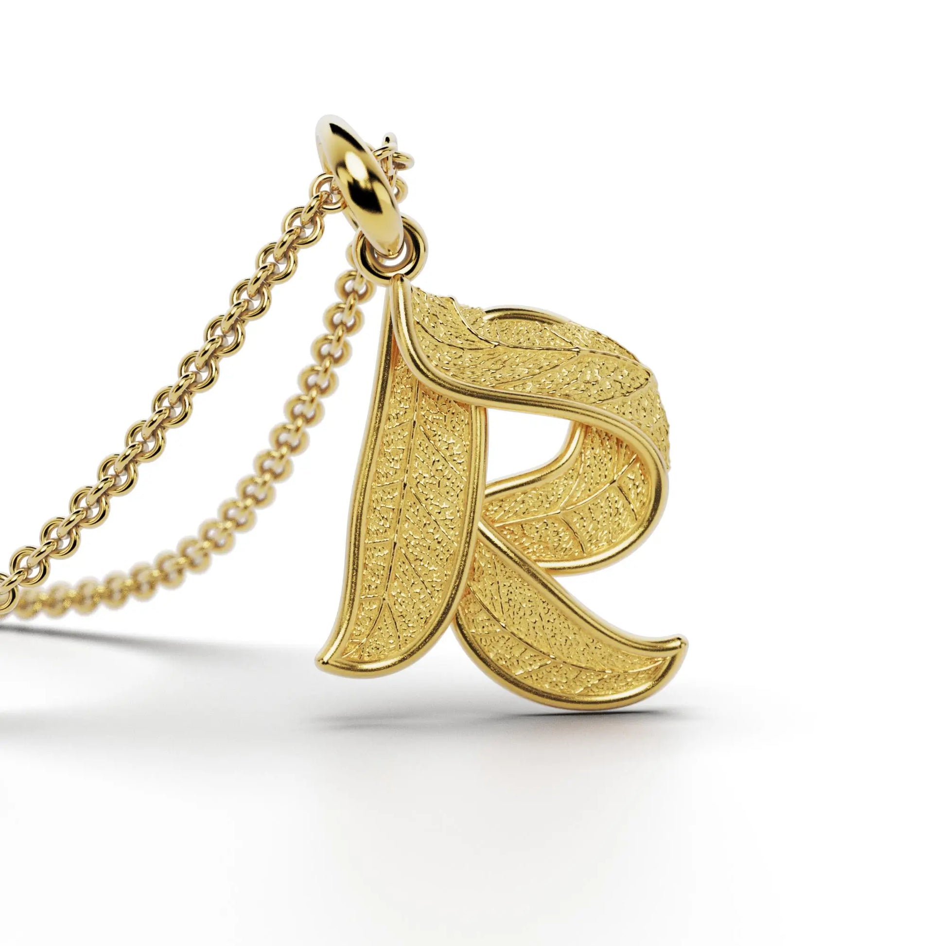 Gold initials pendant with leaf texture, custom made in Italy.
Letter R