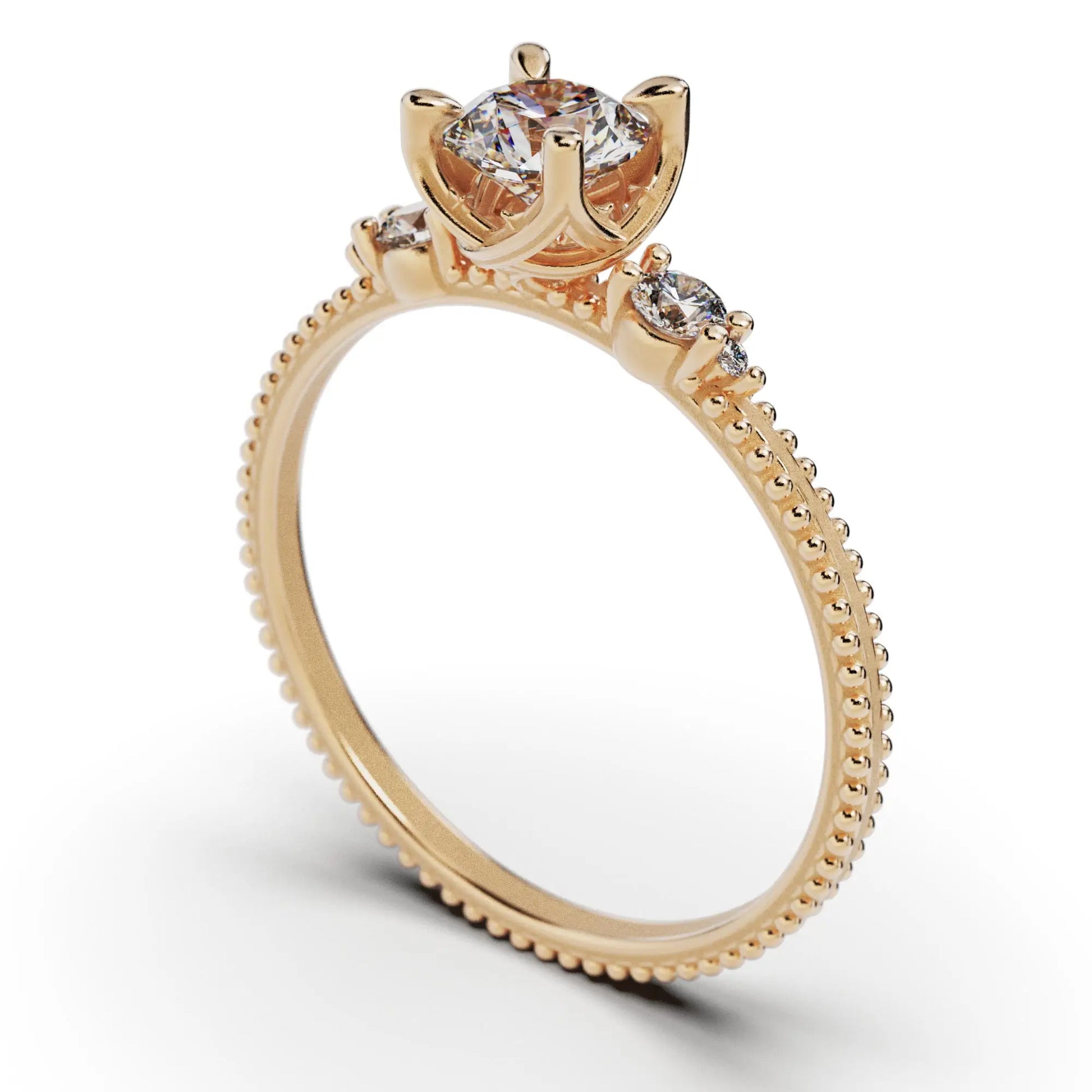 A solitaire diamond ring from the Amore collection, featuring a round-cut diamond in a Venetian-style four-pronged setting. The gold band, available in 14 or 18K, is detailed with milgrane and accented with four smaller diamonds, inspired by Venetian architecture’s timeless romance and artistry.