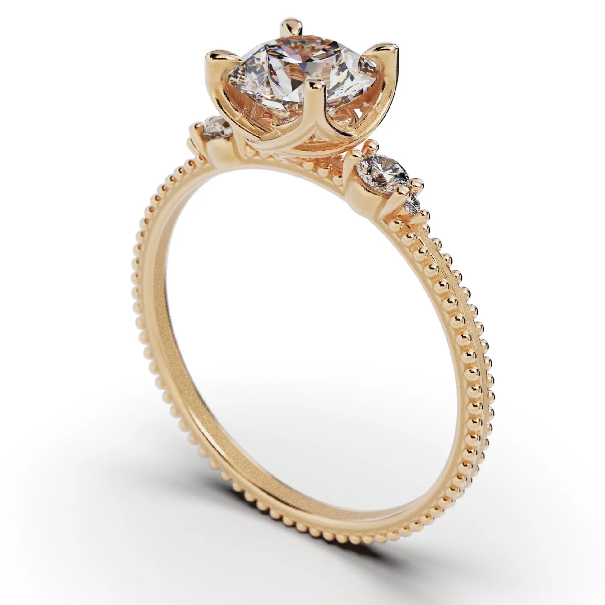 A solitaire diamond ring from the Amore collection, featuring a round-cut diamond in a Venetian-style four-pronged setting. The gold band, available in 14 or 18K, is detailed with milgrane and accented with four smaller diamonds, inspired by Venetian architecture’s timeless romance and artistry.