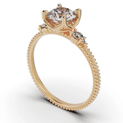 A solitaire diamond ring from the Amore collection, featuring a round-cut diamond in a Venetian-style four-pronged setting. The gold band, available in 14 or 18K, is detailed with milgrane and accented with four smaller diamonds, inspired by Venetian architecture’s timeless romance and artistry.