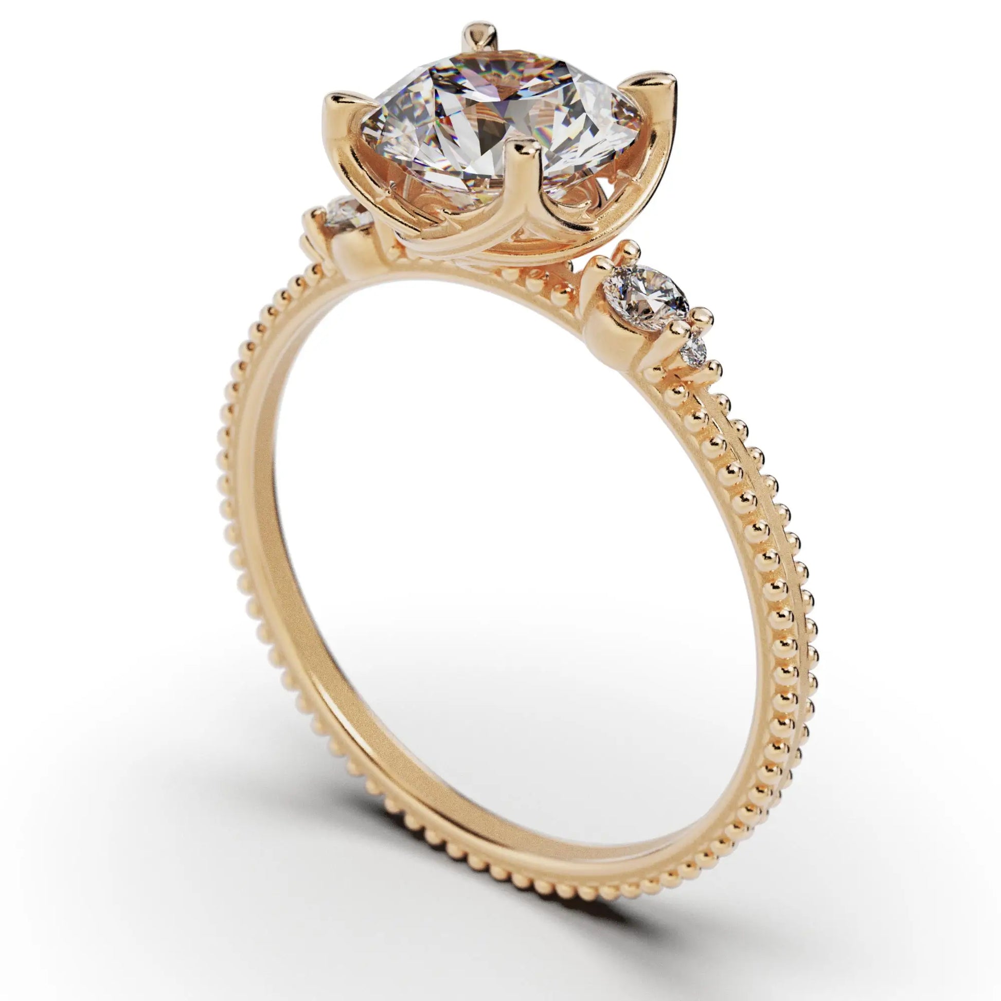 A solitaire diamond ring from the Amore collection, featuring a round-cut diamond in a Venetian-style four-pronged setting. The gold band, available in 14 or 18K, is detailed with milgrane and accented with four smaller diamonds, inspired by Venetian architecture’s timeless romance and artistry.