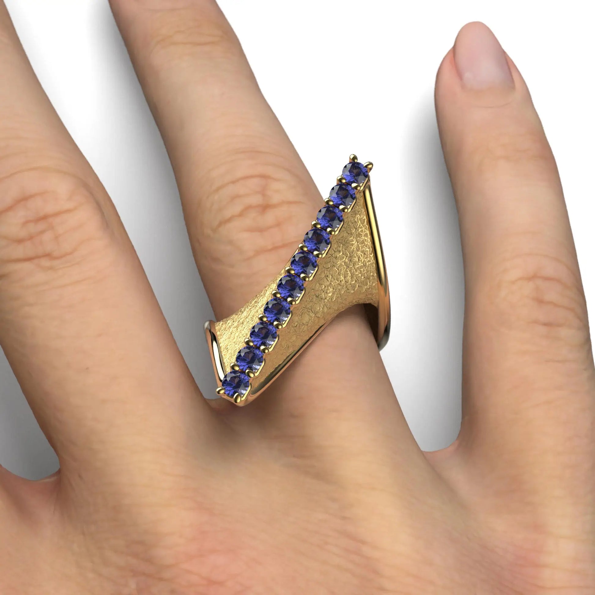 A twisted gold ring with an earth-textured surface and polished edges, featuring 10 round natural tanzanites set along the top ridge, available in 14k or 18k gold.