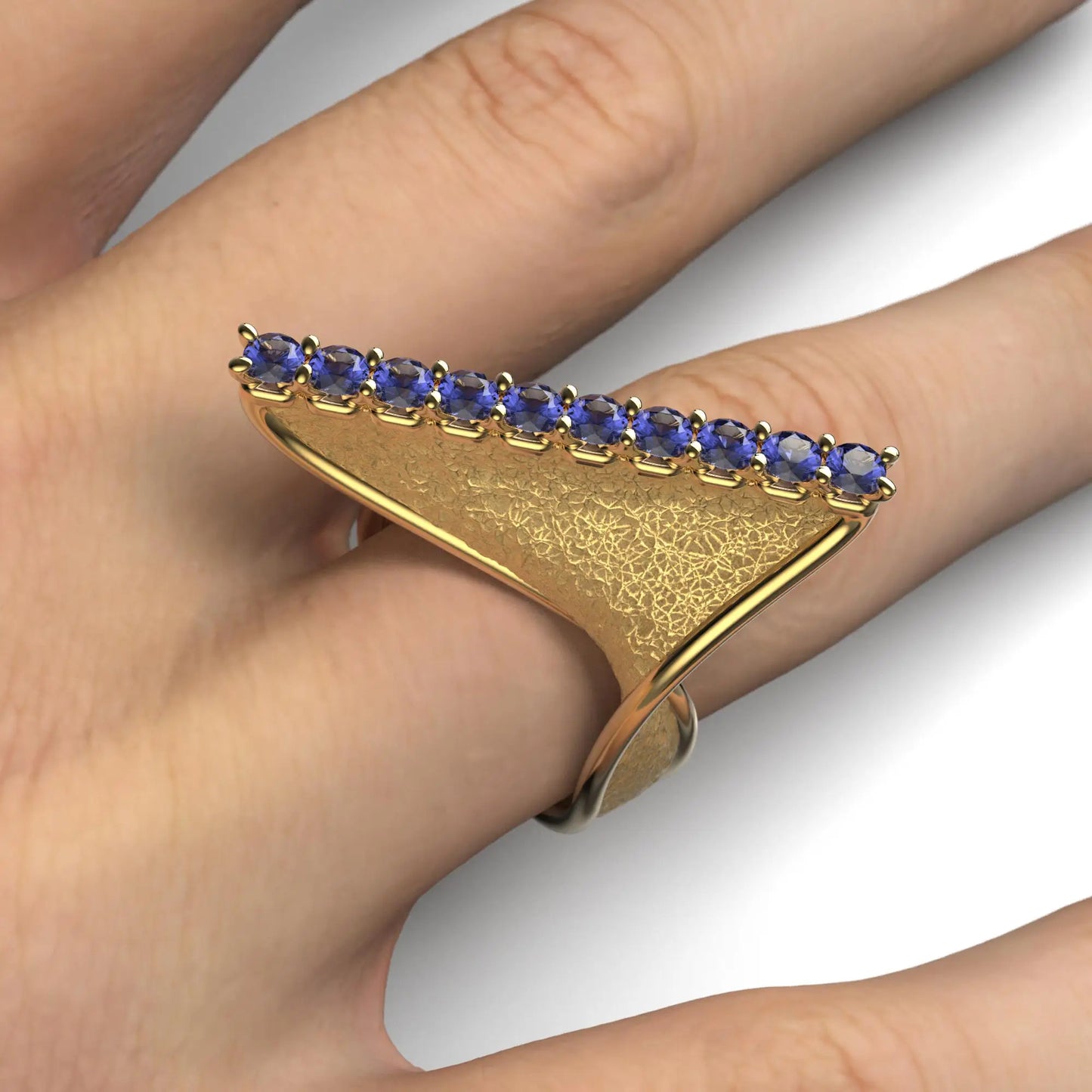 A twisted gold ring with an earth-textured surface and polished edges, featuring 10 round natural tanzanites set along the top ridge, available in 14k or 18k gold.