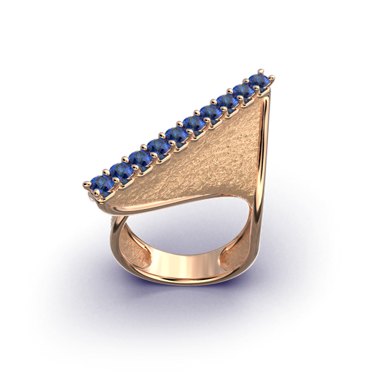 A handcrafted 18k gold ring featuring a modern twisted design with 10 round blue sapphires set along the top ridge. Polished edges with an earth-textured surface.