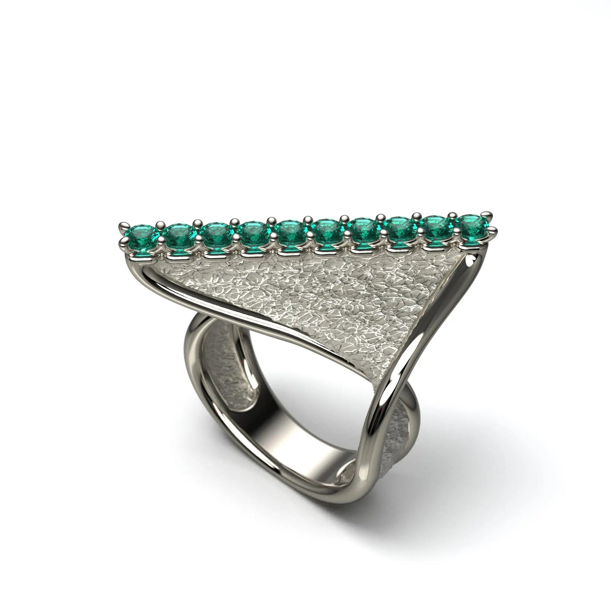 A modern twisted gold ring featuring 10 round natural emeralds set along the top ridge, with polished edges and an earth-textured surface.