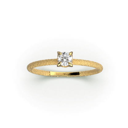 A stunning Italian handmade ring featuring a round, natural white diamond, measuring approximately 3.5mm in diameter and weighing 0.16 carats. The diamond is set on a sleek, handcrafted 18k or 14k solid gold band, meticulously textured to create a striking sparkle effect. The band is approximately 1.6mm wide and 1.6mm thick, enhancing the diamond's brilliance.